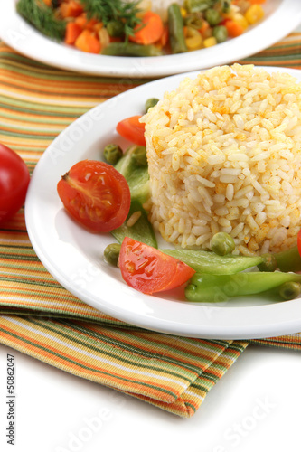 Photo: Delicious risotto with vegetables isolated on white Delicious risotto with vegetables isolated on white