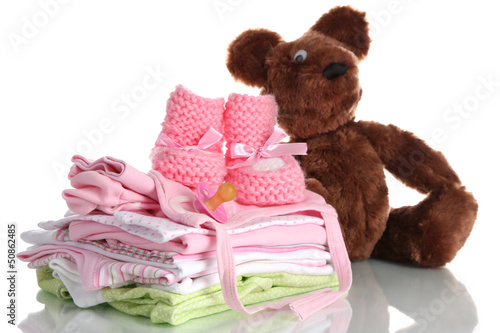 Photo: Pile of baby clothes isolated on white Pile of baby clothes isolated on white