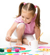 Cute cheerful child play with paints