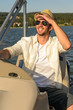 Young man navigating powerboat sunny