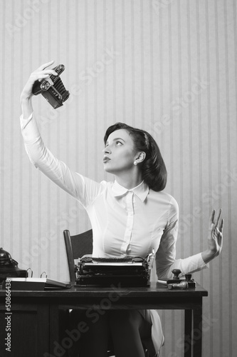 Photo: Beautiful business woman taking a picture of herself with a old Beautiful business woman taking a picture of herself with a old