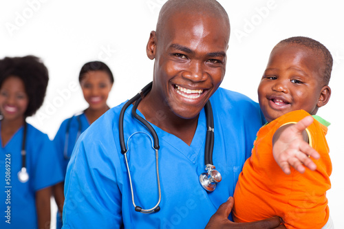 Photo: african pediatric doctor playing with baby boy african pediatric doctor playing with baby boy