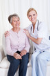 Portrait Of Doctor And Patient Sitting On Couch
