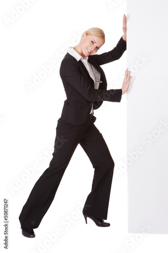 Photo: Businesswoman pushing banner Businesswoman pushing banner