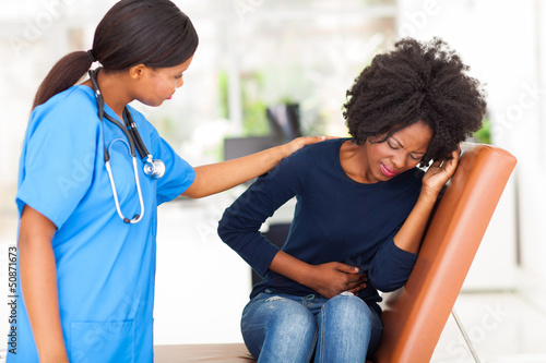 Photo: young african nurse comforting female patient young african nurse comforting female patient