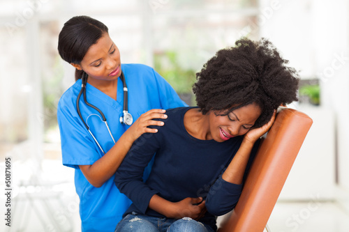 Photo: african female medical worker comforting a sick patient african female medical worker comforting a sick patient