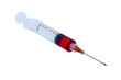 Plastic disposable syringe filled with red liquid.