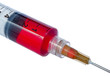 Plastic disposable syringe filled with red liquid.