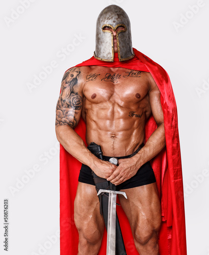 Photo: Brave well looking warrior in red mantle and helmet Brave well looking warrior in red mantle and helmet