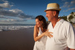 Photo: Happy senior couple on tropical beach at sunset Happy senior couple on tropical beach at sunset