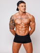 Smoking hot tattoed guy with a hands behind his back