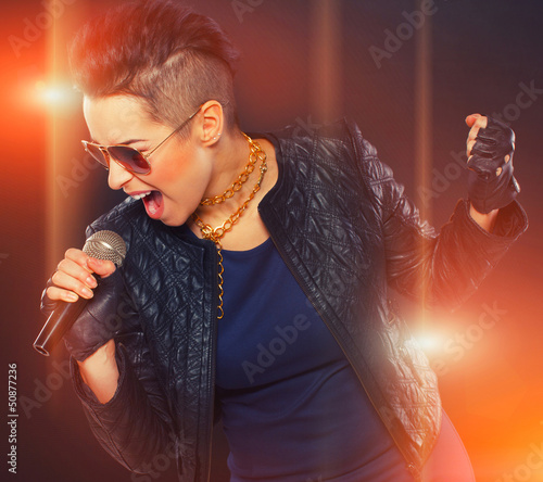 Photo: Hot rocker is singing in microphone Hot rocker is singing in microphone