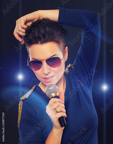 Photo: Stylish singing girl with blue lights Stylish singing girl with blue lights