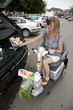 Disabled shopper loading car with shopping