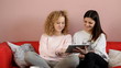 Teenagers with tablet on couch - tracking shot