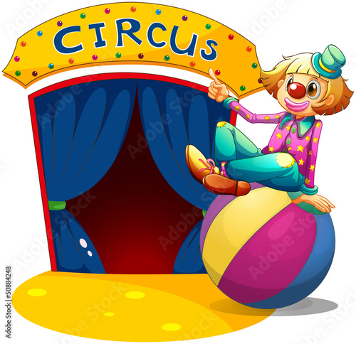 Vector: A clown sitting at the top of a ball pointing the circus house A clown sitting at the top of a ball pointing the circus house
