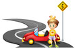 A young boy and his car at the road near the yellow signboard
