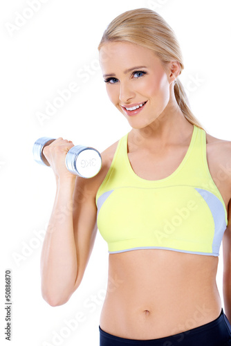 Photo: Close up of blond happy woman with dumbbell Close up of blond happy woman with dumbbell