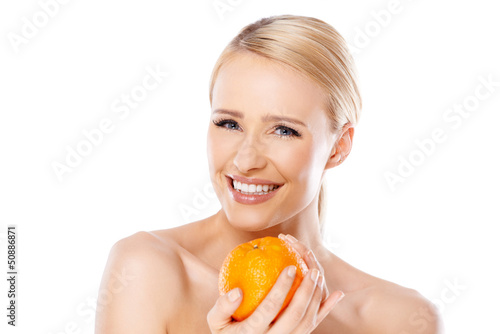 Photo: Smiling girl is holding fresh orange Smiling girl is holding fresh orange
