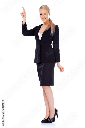 Photo: Smiling blond business woman pointing at copy space Smiling blond business woman pointing at copy space
