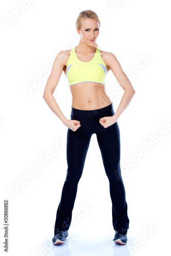 Photo: Sporty blond girl showing her muscles Sporty blond girl showing her muscles