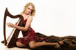 Photo: Blonde woman with a harp in his hand Blonde woman with a harp in his hand