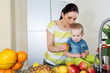 Mother and child making fresh orange juice - healthy life