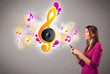 Photo: pretty girl singing and listening to music with musical notes pretty girl singing and listening to music with musical notes