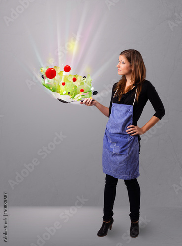 Photo: Young woman cooking fresh vegetables Young woman cooking fresh vegetables