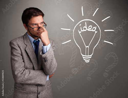 Photo: Young boy comming up with a light bulb idea sign Young boy comming up with a light bulb idea sign