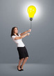 Photo: Pretty lady holding a light bulb balloon Pretty lady holding a light bulb balloon