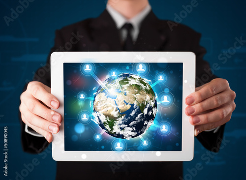 Photo: Businessman presenting 3d earth globe in tablet Businessman presenting 3d earth globe in tablet