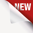 text new on red page under white paper curled corner