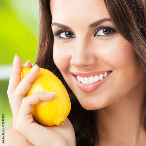 Photo: Young happy smiling woman with limon, outdoor Young happy smiling woman with limon, outdoor