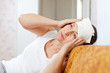   woman stupes  towel to her head