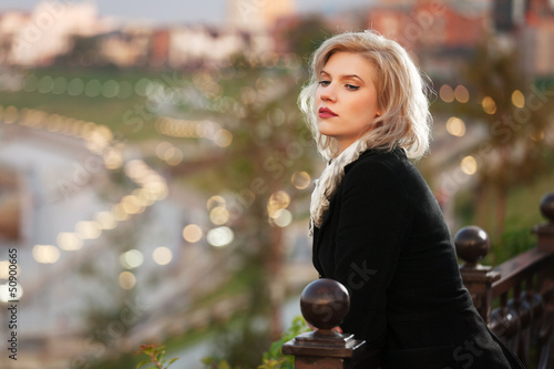 Photo: Young woman against a night city Young woman against a night city