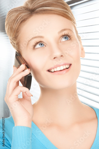Photo: businesswoman with cell phone calling businesswoman with cell phone calling