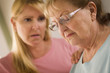Young Woman Consoles Senior Adult Female