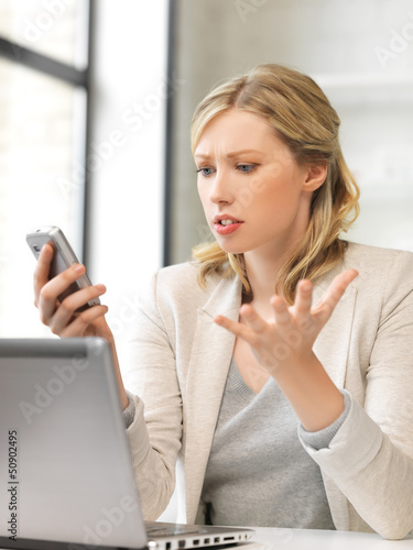 Photo: confused woman with cell phone confused woman with cell phone