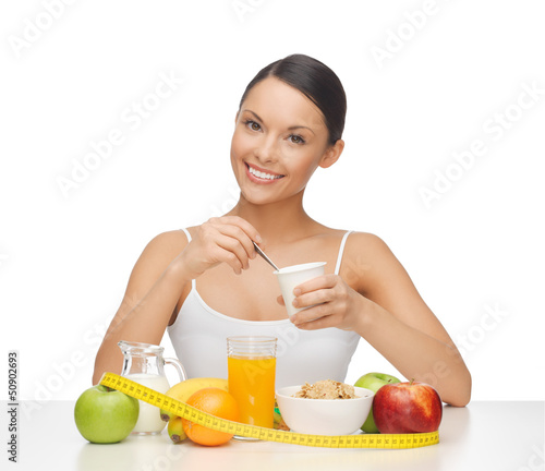 Photo: woman with healthy breakfast and measuring tape woman with healthy breakfast and measuring tape
