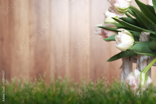 Photo: White tulips with rustic wood background White tulips with rustic wood background