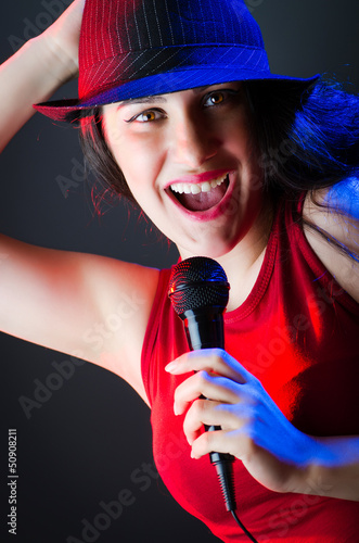 Photo: Female performer at disco with mic Female performer at disco with mic