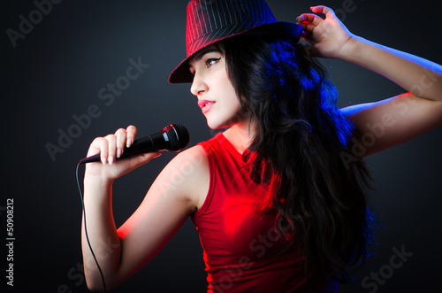 Photo: Female performer at disco with mic Female performer at disco with mic