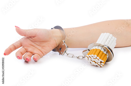 Photo: Addition concept with cigarettes and handcuffs Addition concept with cigarettes and handcuffs