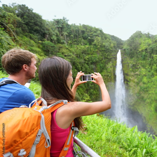 Photo: Tourist couple on Hawaii taking pictures Tourist couple on Hawaii taking pictures