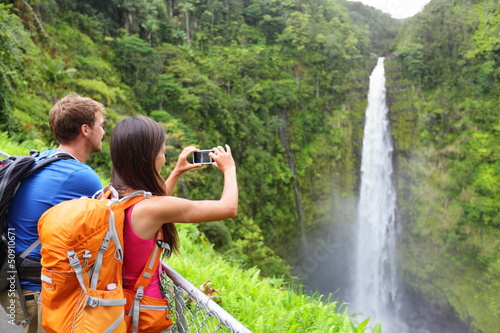Photo: Couple tourists on Hawaii by waterfall Couple tourists on Hawaii by waterfall