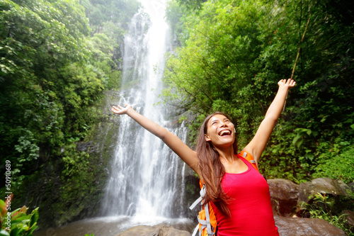 Photo: Hawaii woman tourist excited by waterfall Hawaii woman tourist excited by waterfall