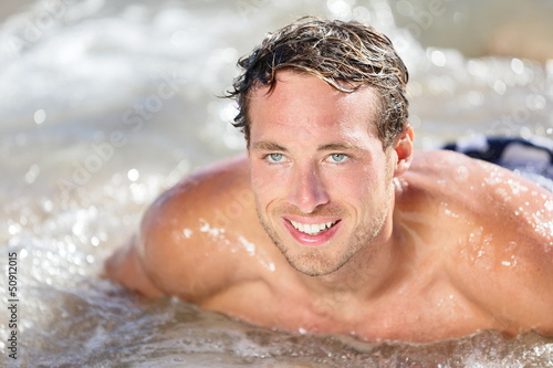 Photo: Beach man having fun in water Beach man having fun in water