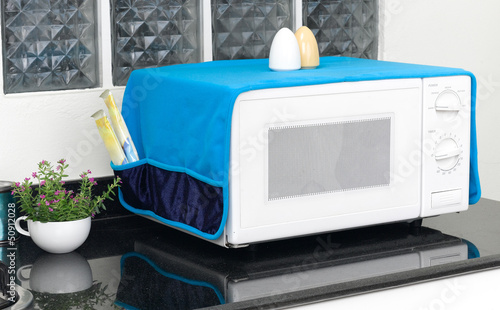 Photo: microwave oven with the cover blanket to protect dust or dirty microwave oven with the cover blanket to protect dust or dirty