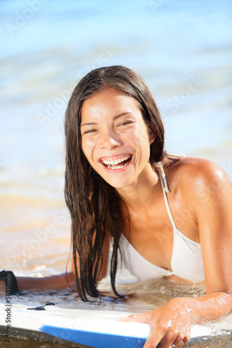 Photo: Water sport fun - beach woman bodyboarding surfing Water sport fun - beach woman bodyboarding surfing